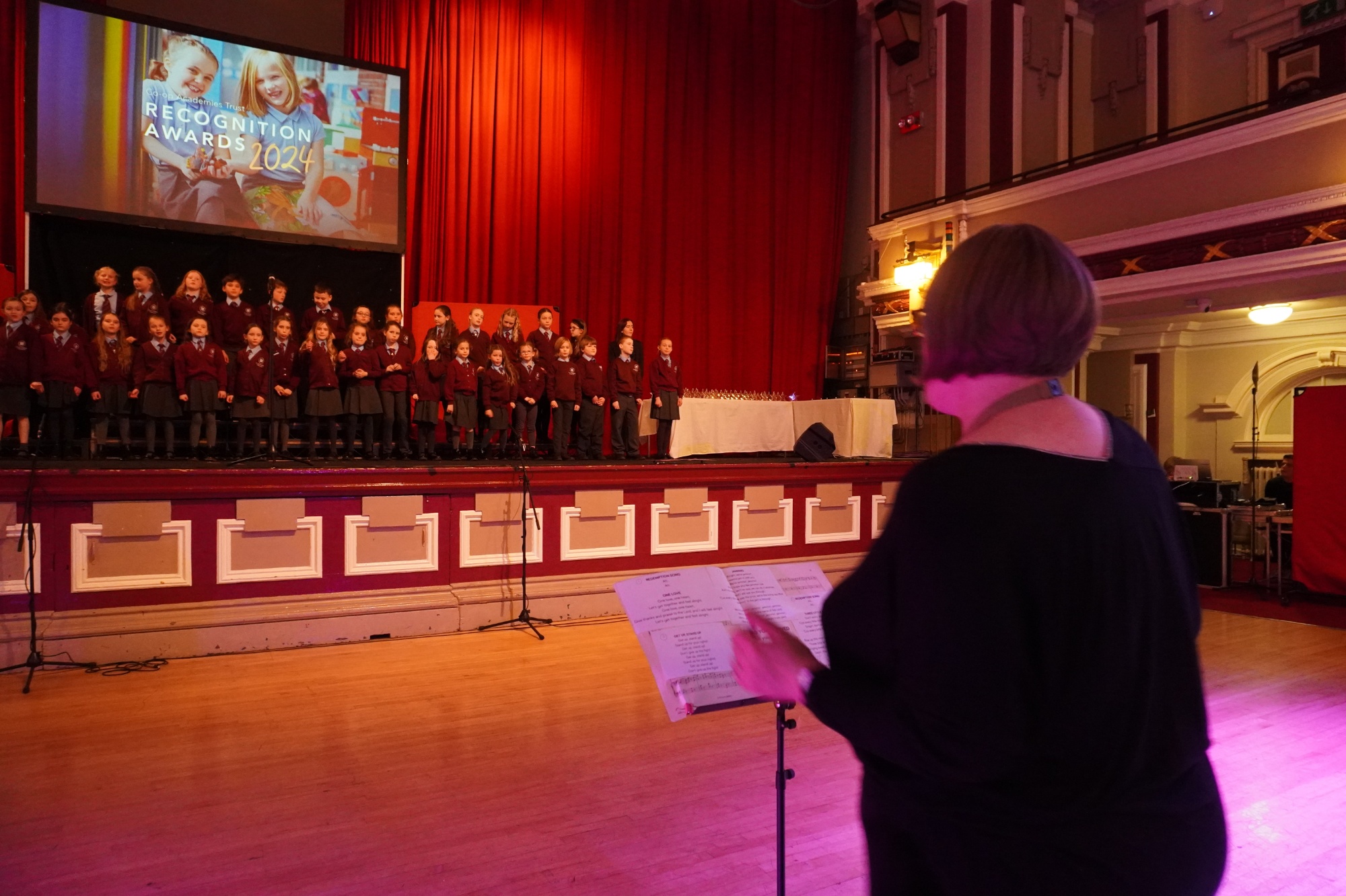 Photo of Mrs Elkin leading the choir